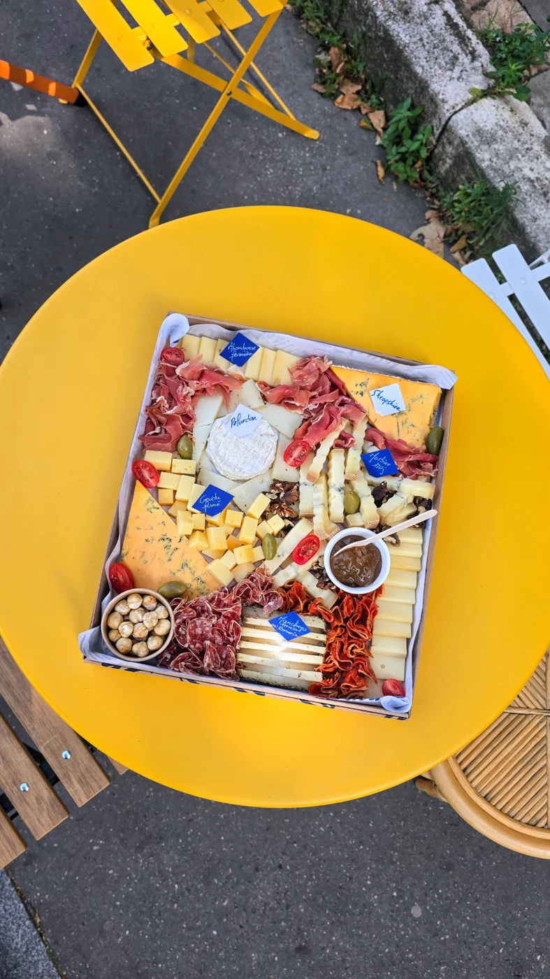Un plateau mixte Mirga posé sur une table jaune en terrasse.